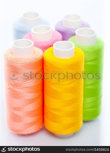 Sewing multicolored threads isolated on a white