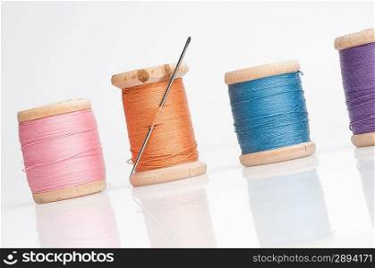 Sewing needle and threads. Isolated on white.