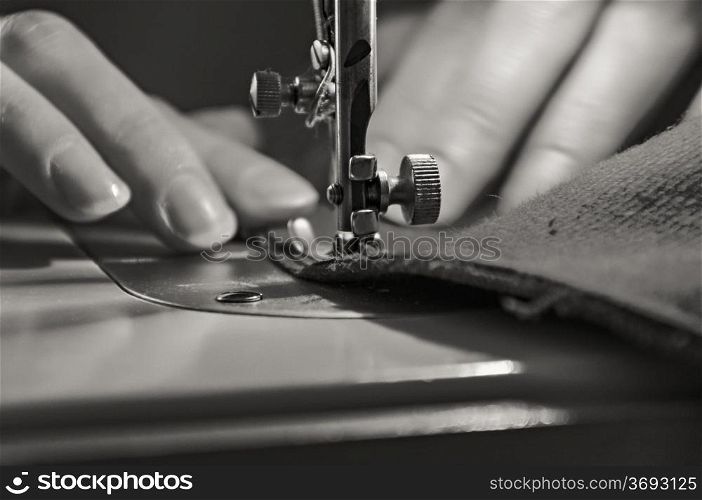 Sewing Process - Women&rsquo;s hands behind her sewing. Monochrome.