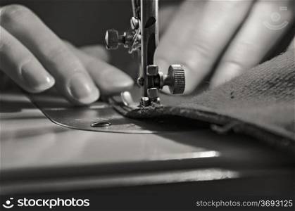 Sewing Process - Women&rsquo;s hands behind her sewing. Monochrome.