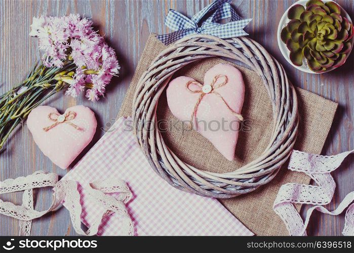 Sewing set of different decorative elements for handicraft and items for handmade on wooden background. Set for needlework pastel colors
