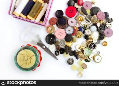 sewing stuff buttons nails thread scissors mixed still life on white