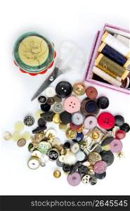 sewing stuff buttons nails thread scissors mixed still life on white