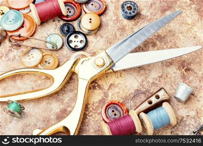 Sewing supplies, scissors, many buttons and threads.Tools for sewing. Set of sewing accessories