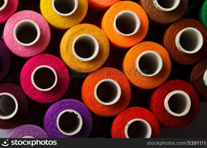 Sewing threads multicolored background closeup