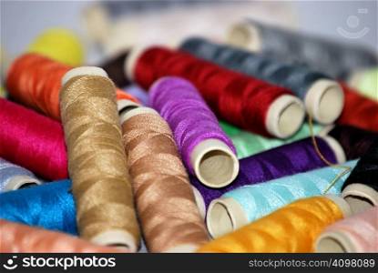 Sewing threads with diverse colors. Clothing and fashion concept