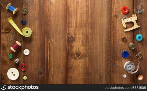 sewing tools and accessories on wooden background