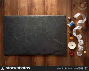 sewing tools and accessories on wooden background