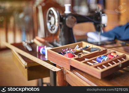 sewing tools and reels of color thread on table. Handmade clothes dressmaking and sewing Concept. sewing tools and reels of color thread on table.