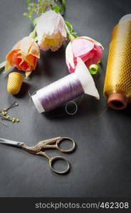 sewing tools thread with scissors and paper flowers