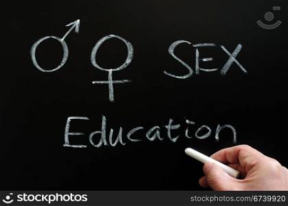 Sex education with gender symbols written on a blackboard