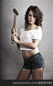 Sex equality and feminism. Sexy girl holding hammer tool. Attractive woman working as repairman or mechanic.