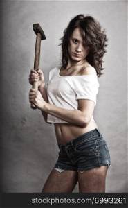 Sex equality and feminism. Sexy girl holding hammer tool. Attractive woman working as repairman or mechanic.