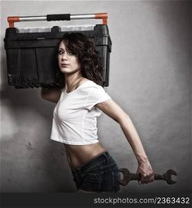 Sex equality and feminism. Sexy girl holding toolbox and wrench spanner tool. Attractive woman working as repairman or mechanic