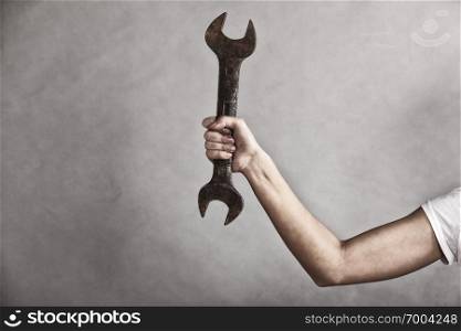 Sex equality and feminism. Wrench spanner in hand of female construction worker. Girl woman working as repairman.