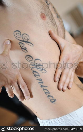 sex machine tattoo on handsome man stomach