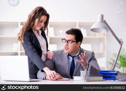 Sexual harassment concept with man and woman in office