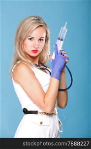 Sexual woman in nurse suit with stethoscope and syringe blue background