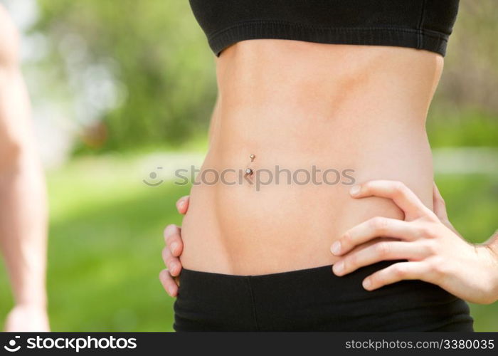 Sexy and fit belly on young woman against blur background