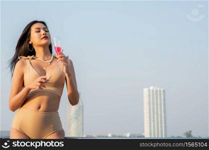 Sexy Asian Women in Bikini with Champagne Glass on her Private Yacht.