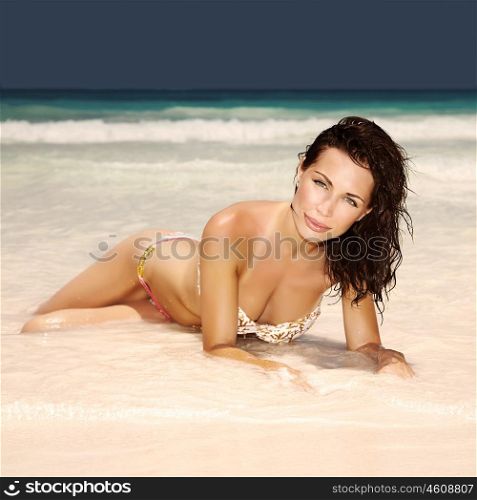 Sexy attractive woman lying down on the beach, perfect body, healthy lifestyle, relaxation outdoors, enjoying dayspa, summer vacation, sensuality concept
