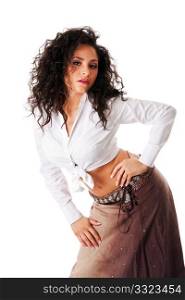 Sexy beautiful Caucasian Hispanic Latina young woman with brown curley hair. Cute tanned brunette, ethnic girl in white knotted shirt and brown skirt standing showing belly button, isolated.