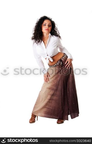 Sexy beautiful Caucasian Hispanic Latina young woman with brown curley hair. Cute tanned brunette, ethnic girl in white knotted shirt and brown skirt standing showing belly button, isolated.