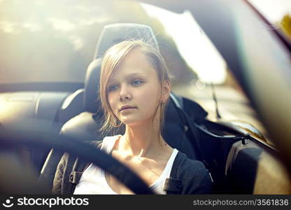 sexy beautiful young woman driving her convertible car