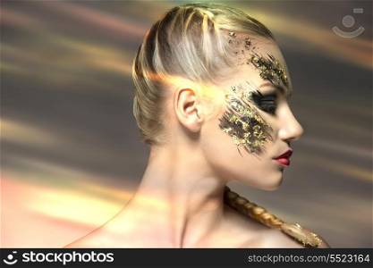 sexy blonde girl posing in beauty portrait with bride hair-style, naked shoulders and strange strong creative make-up