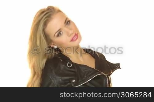 Sexy blonde girl wearing a black jacket looking directly at the camera, studio on white