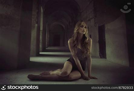 Sexy blonde lady sitting alone in the dungeon