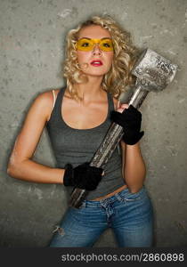 Sexy blonde with big metal hammer