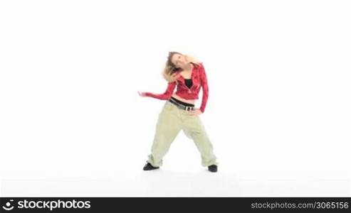 Sexy Blonde Woman Hip Hop Dancing in vivid red top and baggy pants, full length profile on white