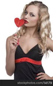 sexy blonde woman with black dress, long wavy hair and red lollipop