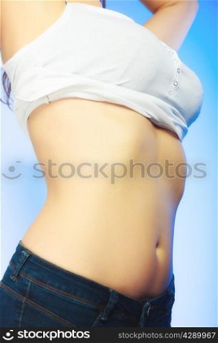 Sexy body belly of young plus size woman studio shot on blue