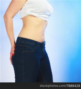 Sexy body belly of young plus size woman studio shot on blue