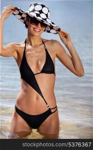 sexy brunette in black bikini with assorted sun hat