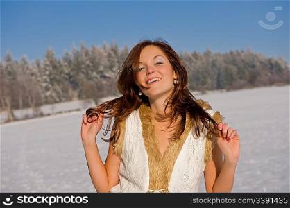 Sexy brunette in winter outfit on snow