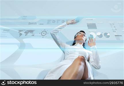Sexy brunette wearing white suit logging into the system (Attractive young adults in futuristic interfaces / interiors series)
