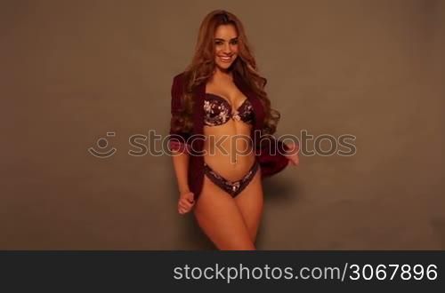 Sexy brunette woman in lingerie dancing in the studio
