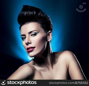 sexy brunette woman with red lips in blue light