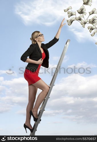 sexy business woman with elegant suit climbing ladder with ambition