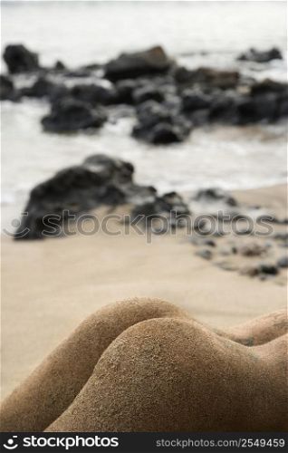Sexy Caucasian young adult female butt on beach.