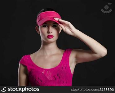Sexy fashion woman posing in studio and dressing pink clothes