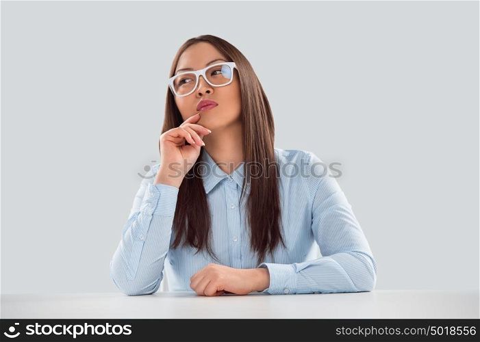 Sexy fashionable asian business woman sitting alone at office