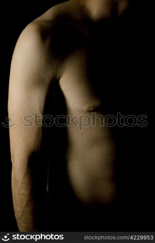 sexy fit naked male body on black background low key