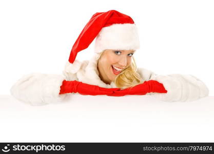 Sexy Girl dressed as Santa Claus Points Finger to Advertising Space