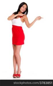 Sexy latin in short red hot dress isolated Pointing and looking to the side. Casual young business woman looking, pointing and smiling at copy space.