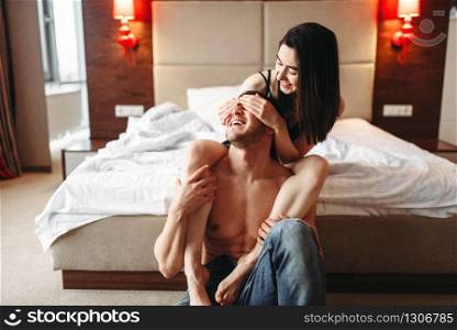 Sexy love couple hugging and have a fun in bedroom. Intimate games in bed, sex lovers intimacy
