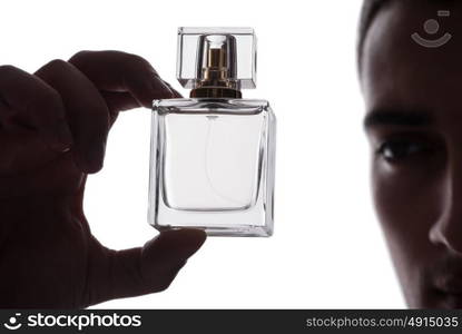 Sexy man with bottle of perfume